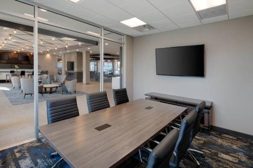 a conference room with a wooden table and chairs at SpringHill Suites by Marriott Indianapolis Keystone in Indianapolis
