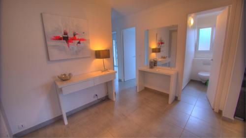 a bathroom with a sink and a toilet and a lamp at Beau 2 pièces 3 étoiles Vue Mer Garage Privé 150m plages wifi in Cannes