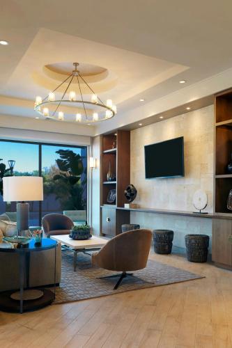 a living room with a couch and a tv at TownePlace Suites by Marriott Orlando Downtown in Orlando