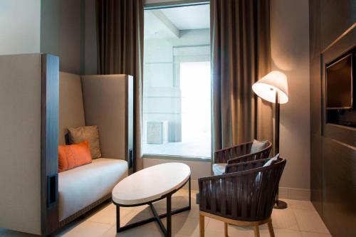 a living room with a couch and a table and a chair at Franklin Marriott Cool Springs in Franklin