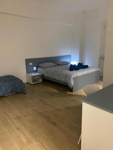 a bedroom with a bed in a room with wooden floors at Via Piave 98 in Cosenza