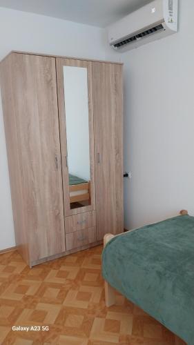 a bedroom with a wooden door with a window at Apartman Mina in Pirot