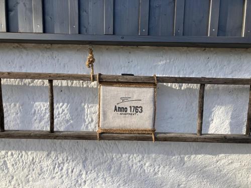a sign on the side of a building with a window at Anno 1763 in St. Wolfgang