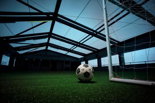 a soccer ball on the field in a building at Hotel Football, Old Trafford, a Tribute Portfolio Hotel in Manchester