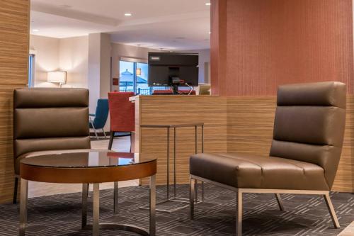 a lobby with two chairs and a table at TownePlace Suites by Marriott Merced in Merced