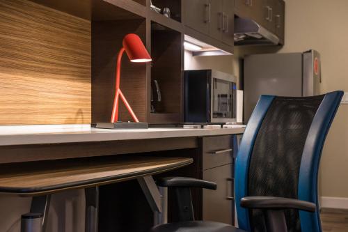 a red lamp sitting on top of a kitchen counter at TownePlace Suites by Marriott Merced in Merced