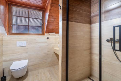 a bathroom with a toilet and a shower at Rezort u Bobiho in Nový Tekov