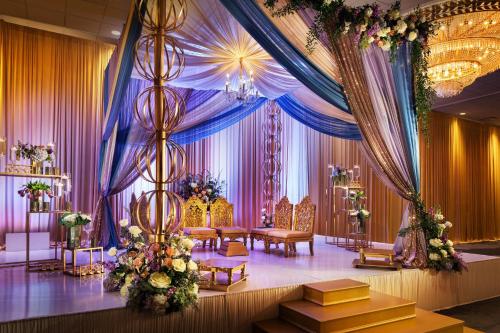 a room with a stage with purple and gold curtains at The Westin Galleria Houston in Houston