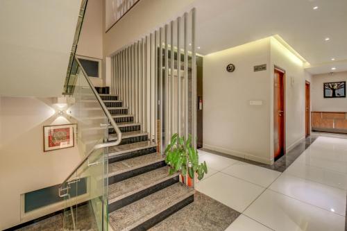 a staircase in a house with a glass railing at Hotel J N Stay Mysore - 12 Minutes to Mysore Palace in Mysore