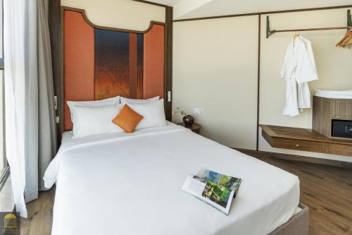 Ένα ή περισσότερα κρεβάτια σε δωμάτιο στο Apec Wyndham Luxe Escape Mui Ne