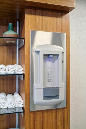 a coffee dispenser on a wall next to towels at SpringHill Suites by Marriott Wixom Novi in Wixom