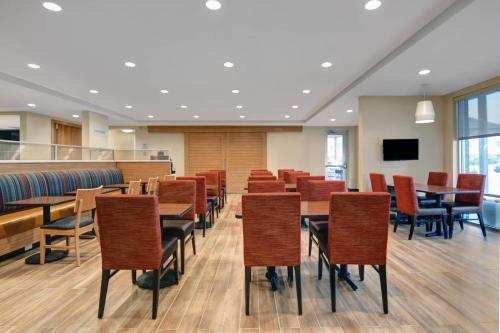 a room with tables and chairs and a tv at TownePlace Suites By Marriott Lima in Lima