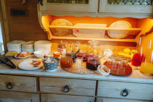 a kitchen counter with many jars of food on it at Garni Cir in Santa Cristina in Val Gardena