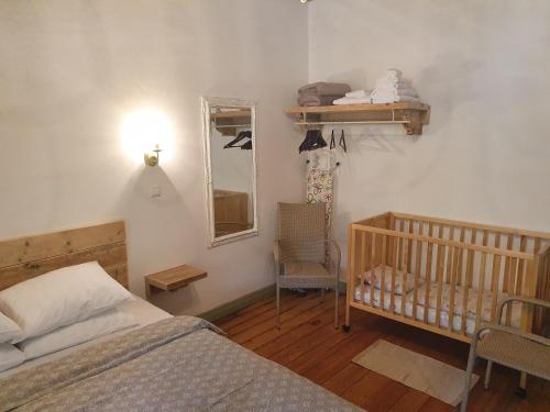 a bedroom with a bed and a mirror and a crib at Apartamenti Strand in Saulkrasti