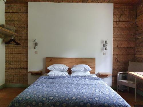 a bedroom with a bed with two pillows at Apartamenti Strand in Saulkrasti