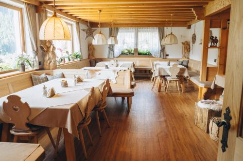 a restaurant with tables and chairs in a room at Garni Cir in Santa Cristina in Val Gardena