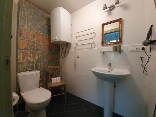 a bathroom with a toilet and a sink at Apartamenti Strand in Saulkrasti