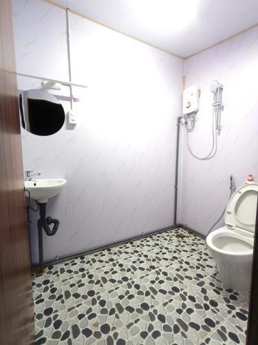 a bathroom with a toilet and a sink at Amikaje Farm in Xuan An