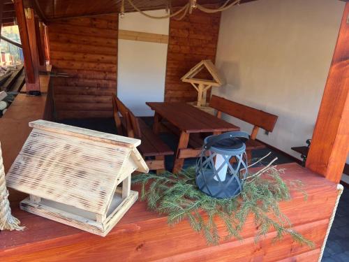 a table and chairs and a bird house on a table at Gospodarstwo Agroturystyczne in Żabnica