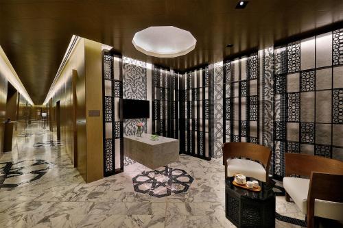 a lobby with a bathroom with a tub and a sink at W Muscat in Muscat