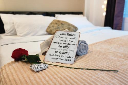 a sign on a bed with a rose on it at Mangrove beach house Sri Thanu in Srithanu