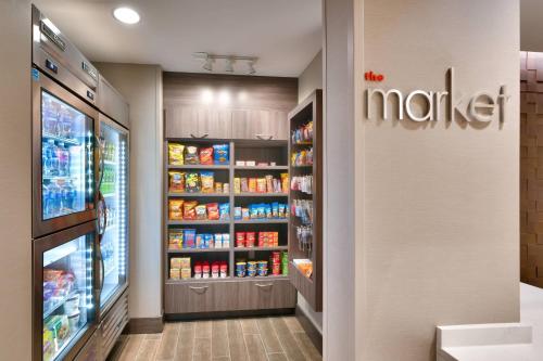 a grocery store aisle with a refrigerator with food at Residence Inn by Marriott Phoenix West/Avondale in Avondale