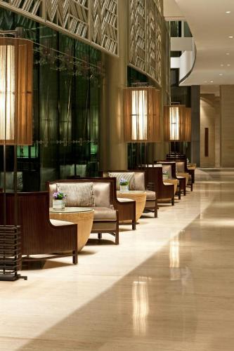 a lobby with couches and tables in a building at The Westin Gurgaon, New Delhi in Gurgaon