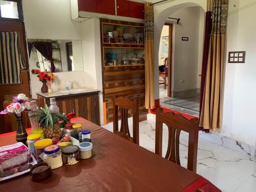 a kitchen with a table with food on it at Kolkata Sarkar Villa Homestay in Kolkata