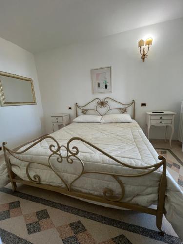 a bedroom with a large bed in a white room at Palazzo Giannotte Suite & Spa in Ostuni