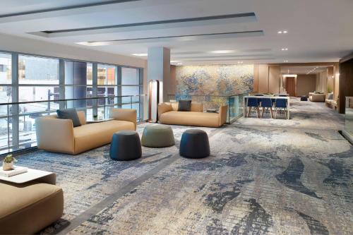a large lobby with couches and a bar in a building at Lexington Marriott City Center in Lexington