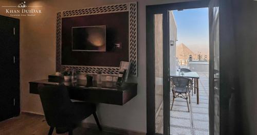 a bathroom with a sink and a mirror with a view at Khan Duidar Inn - Pyramids View Rooftop in Cairo