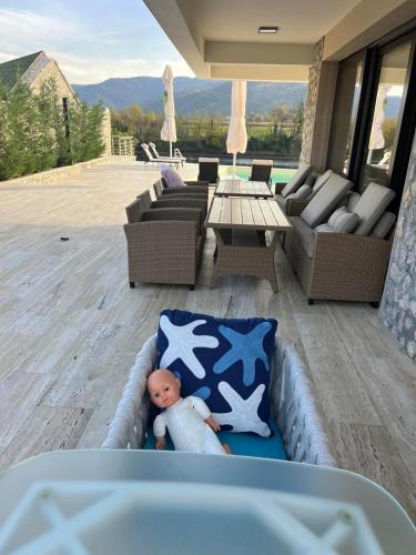a baby doll in a inflatable bed on a patio at Orlovo gnezdo in Ljubovija