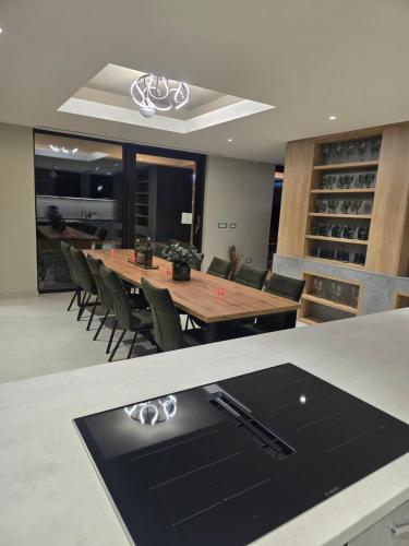 a kitchen and dining room with a table and chairs at Orlovo gnezdo in Ljubovija