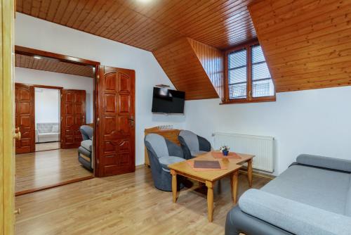 a living room with a couch and a table at Rezort u Bobiho in Nový Tekov