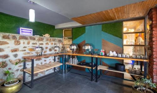 a bar with green walls and wooden shelves at Treebo Vista Lago With Lake View in Bhīm Tāl