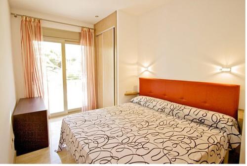 a bedroom with a large bed and a window at Villa Saturn in Alcudia