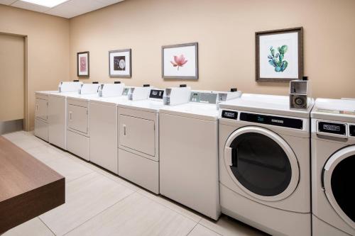 a laundry room with a row of washers and dryers at Residence Inn by Marriott Phoenix Downtown in Phoenix
