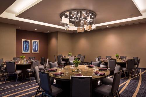 a conference room with tables and chairs and a chandelier at Residence Inn by Marriott Phoenix Downtown in Phoenix