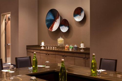 a restaurant with two tables and three mirrors on the wall at Residence Inn by Marriott Phoenix Downtown in Phoenix