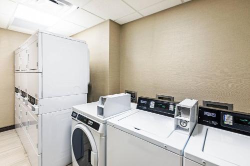 a laundry room with a washer and a refrigerator at TownePlace Suites Dallas Plano/Richardson in Plano
