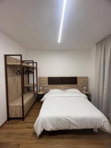 a bedroom with a large bed with a white bedspread at B&B La Quarantola in Pisa