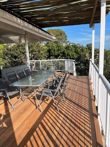 a patio with a table and chairs on a deck at Upper Deck in Kenton on Sea