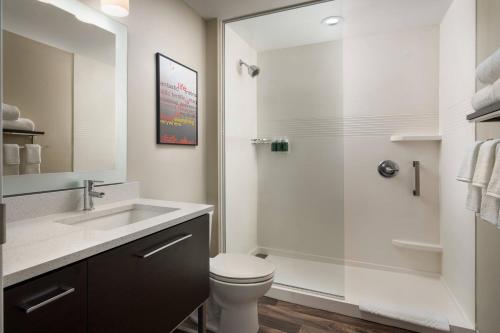 a bathroom with a shower and a toilet and a sink at TownePlace Suites by Marriott Memphis Olive Branch in Olive Branch