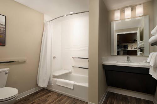 a bathroom with a shower and a sink and a toilet at TownePlace Suites by Marriott Memphis Olive Branch in Olive Branch