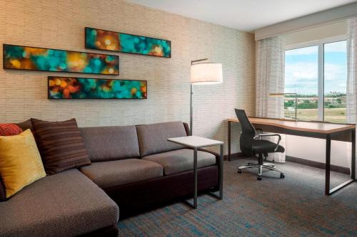 a living room with a couch and a desk at Residence Inn by Marriott Wheeling/St. Clairsville in Saint Clairsville