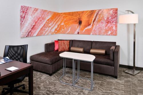 a living room with a couch and a table at SpringHill Suites by Marriott Oklahoma City Airport in Oklahoma City