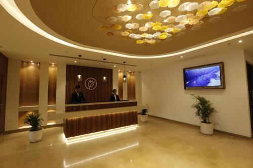 a lobby with two men standing in front of a podium at Tulip Inn Zirakpur in Chandīgarh