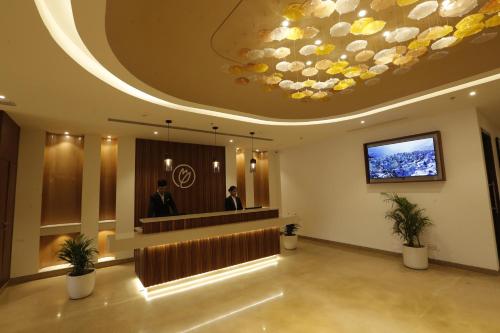 a lobby with a waiting area with a large ceiling at Tulip Inn Zirakpur in Chandīgarh