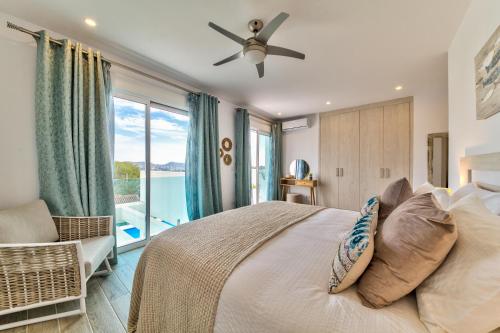 テウラーダにあるLa Vista - Modern Luxury for 12 Guestsのベッドと大きな窓のある寝室