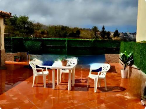 a white table and chairs on a patio with a pool at Magnifique appartement vue sur mer & baie d'Alger in Alger